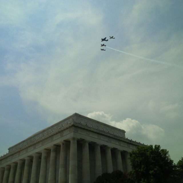 Missing Man formation, still together, with (nearest to farthest) Mustang, Avenger, Corsair, Warhawk.